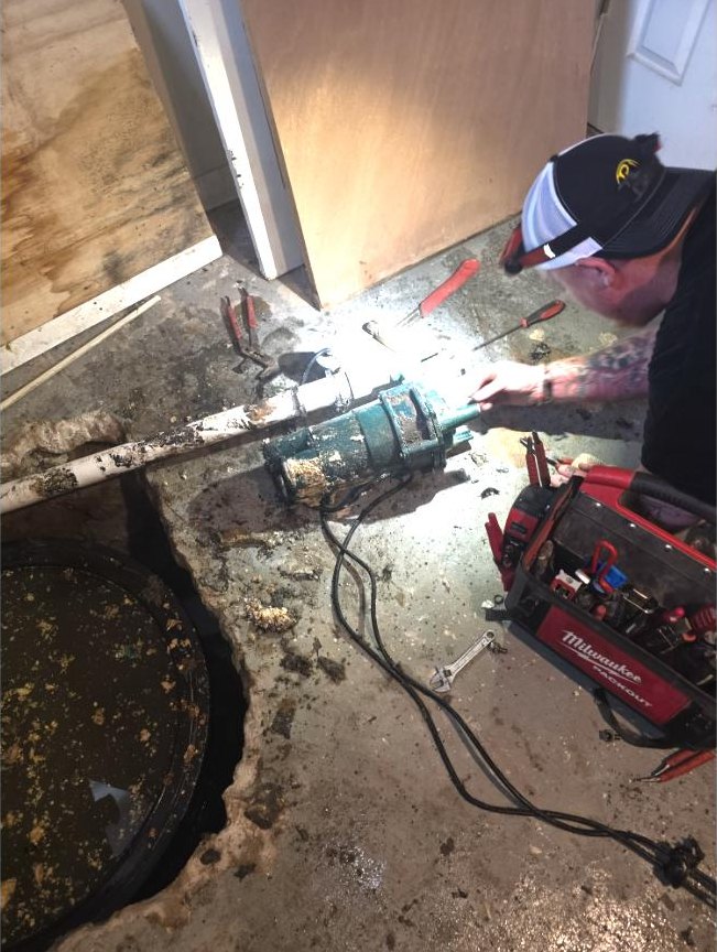 Old School plumber replacing an ejector pump