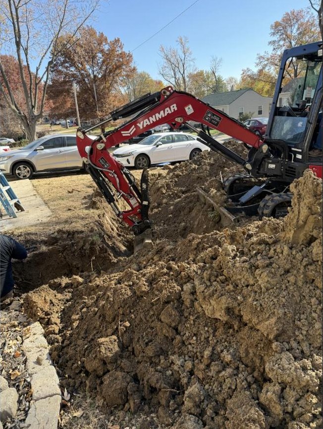 Excavator digging a sewer trench