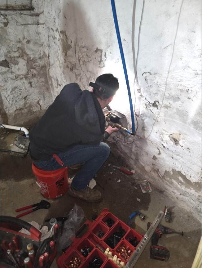 Old School plumber repairing a basement water line